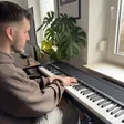 Ramon at his digital piano beside a window
